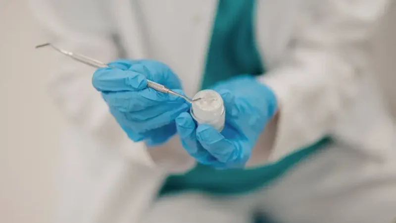 Close-up of a dentist preparing a teeth filling paste