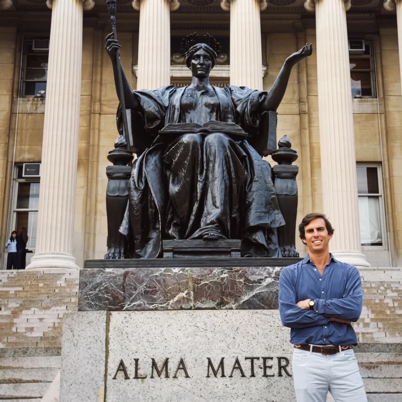 Dr. Astolfi posing in front of the Alma Mater statue at Columbia University.